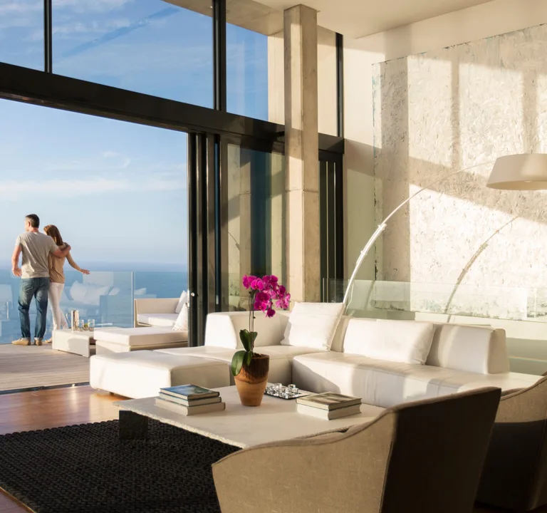 Couple in a modern living space overlooking the water